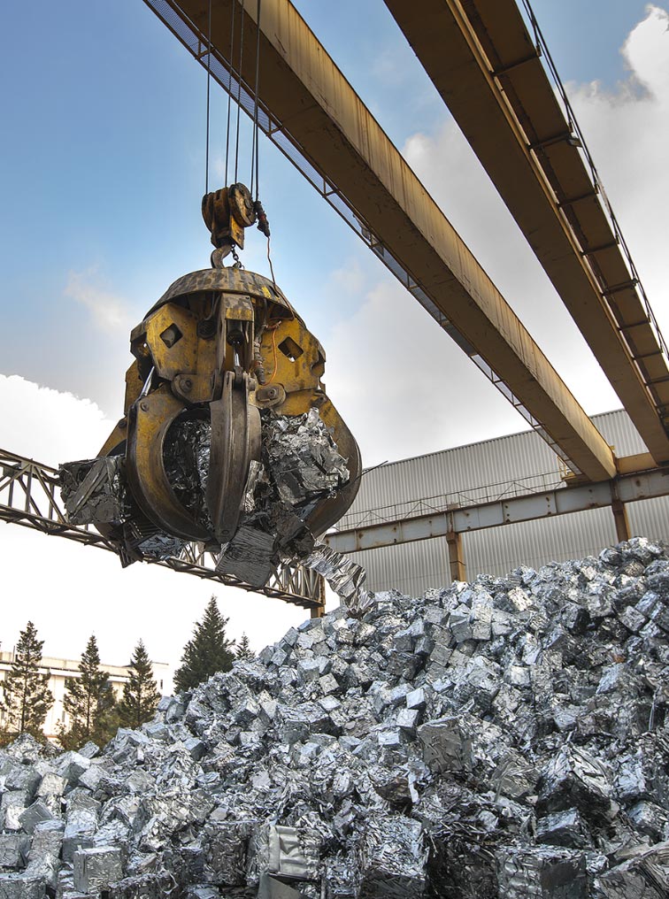 Large mechanied arm grabbing recycled aluminum